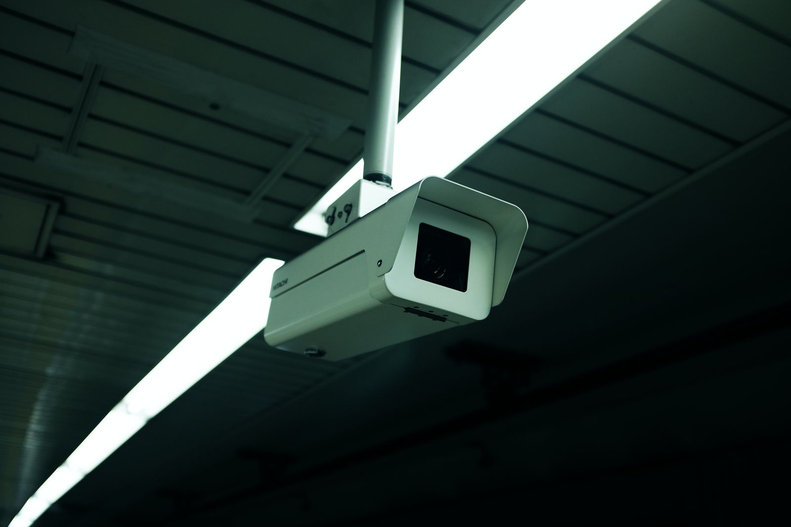 Indoor security camera mounted on a ceiling inside a commercial space