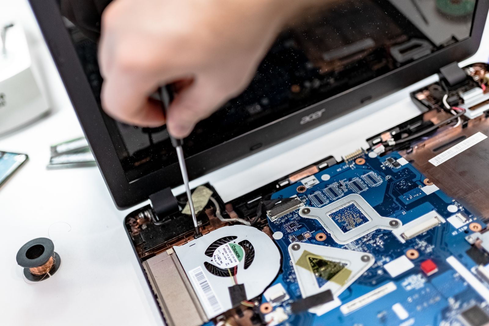 Technician repairing the motherboard of a laptop