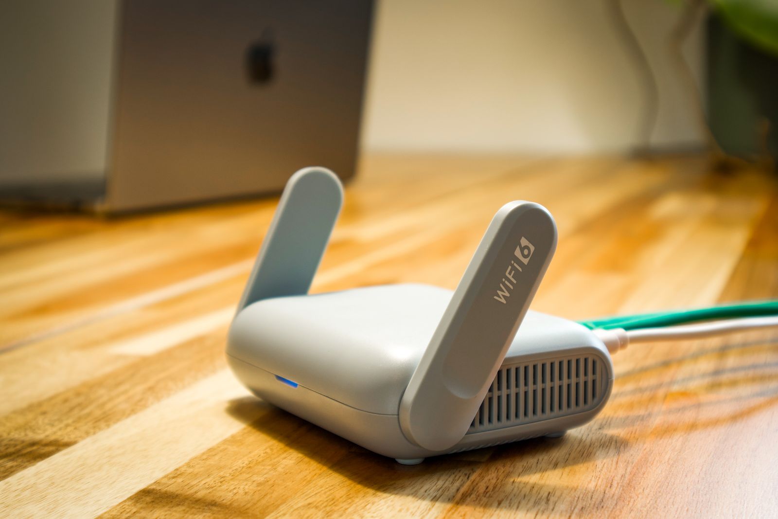 Modern wireless router with antennas on a desk
